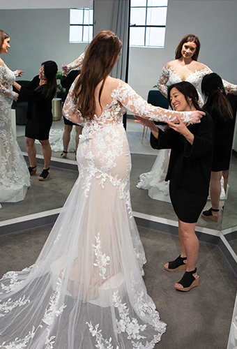 Bridal stylist helping a bride customize sleeves