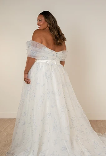Plus size bride wearing printed a-line wedding dress with off-the-shoulder straps and high leg slit