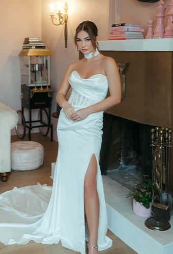 Bride wearing strapless column wedding dress with sweetheart neckline and high leg slit