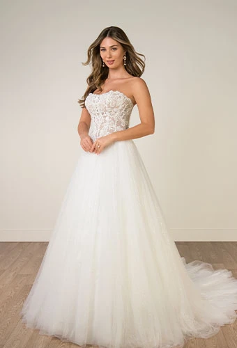 Bride wearing strapless a-line wedding dress with lace appliques and tulle skirt