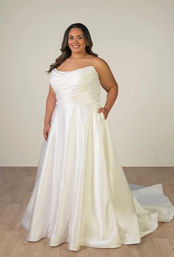 Plus size bride wearing strapless wedding dress with scoop neckline