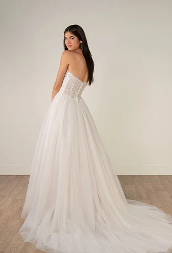Bride wearing strapless a-line wedding dress with exposed boning and tulle skirt