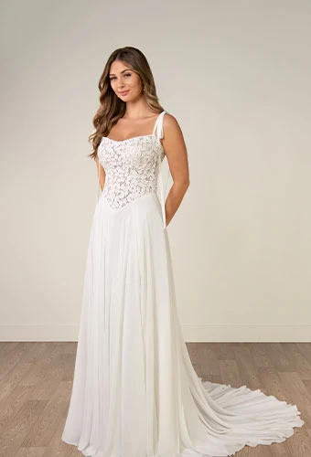 Bride wearing a-line wedding dress with tie straps and lace bodice