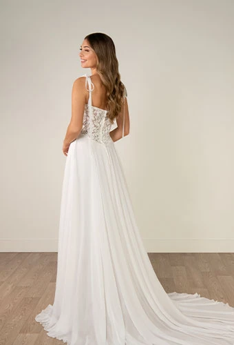 Bride wearing a-line wedding dress with tie straps and lace bodice