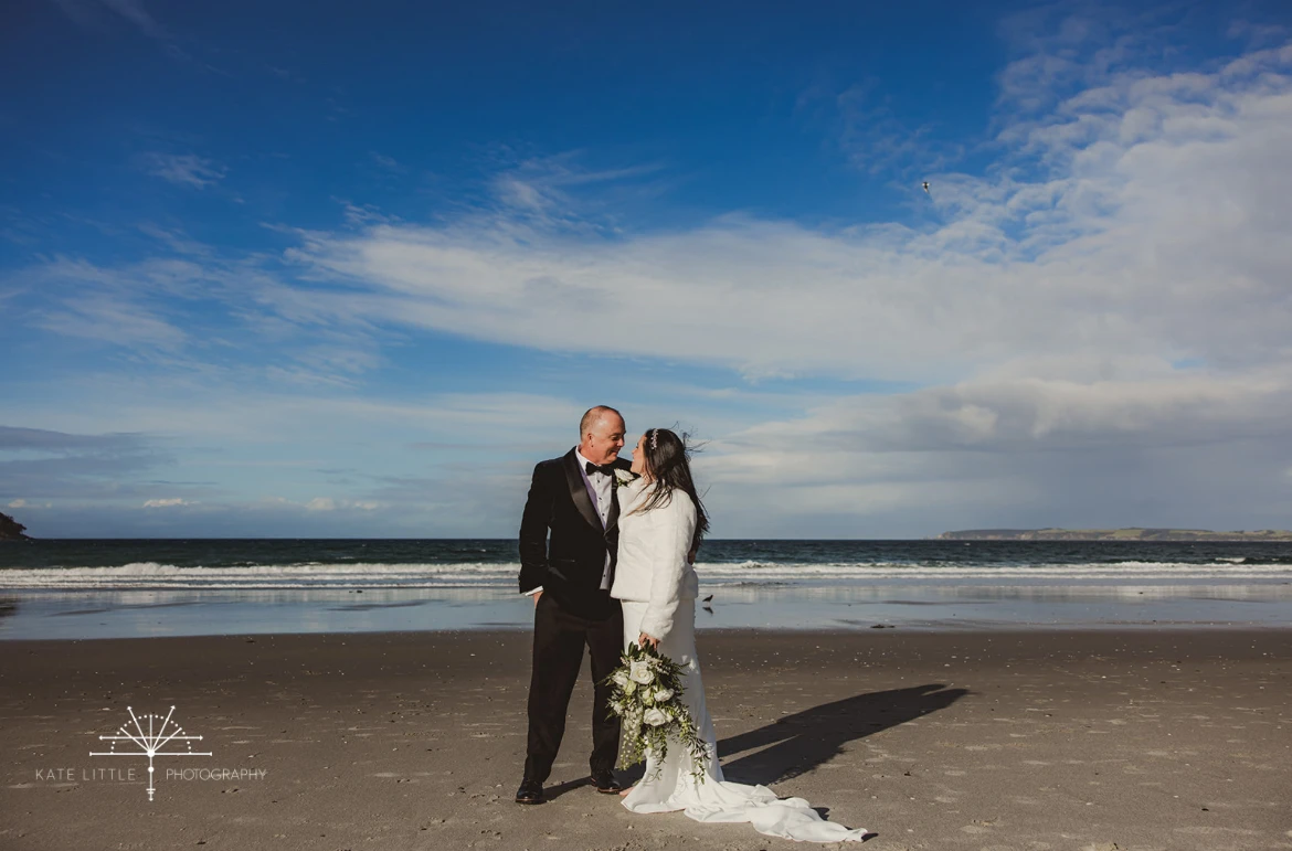 True bride Tanya posing with her husband on the beach