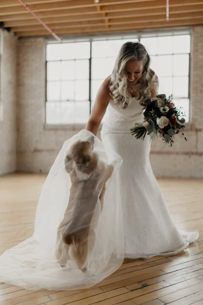 True bride Alex posing in her wedding gown with her dog