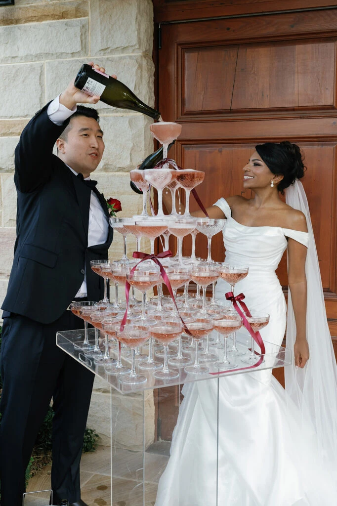 True bride Anna doing a champagne pyramid with her husband