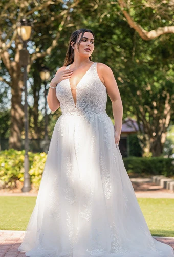 Plus size bride wearing lace a-line wedding dress with plunging v-neckline