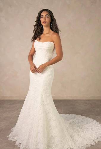 Bride wearing fit-and-flare strapless wedding dress with allover lace