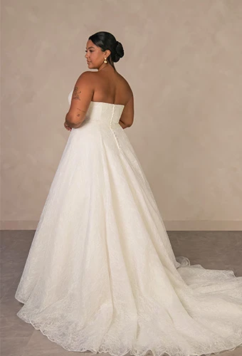 Plus size bride wearing strapless a-line wedding gown with allover lace and sweetheart neckline