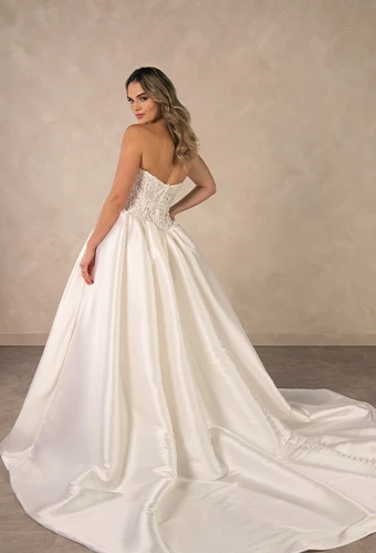 Bride wearing minimalist strapless ballgown wedding dress with a basque waist