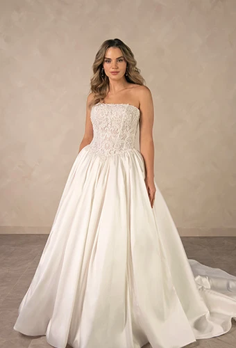 Bride wearing minimalist strapless ballgown wedding dress with a basque waist