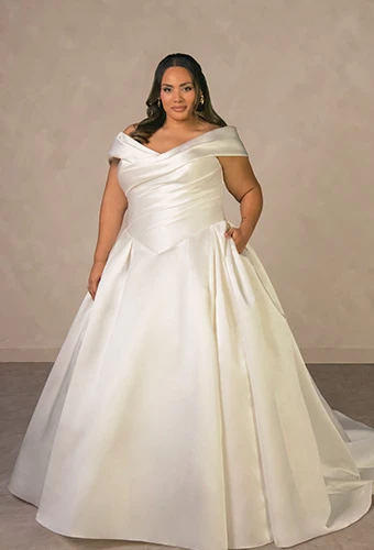 Plus size bride wearing satin ballgown wedding dress with off-the-shoulder straps