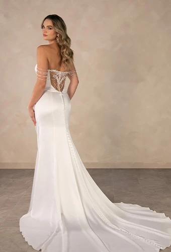 Bride wearing strapless column wedding dress with draped pearls and lace back detail