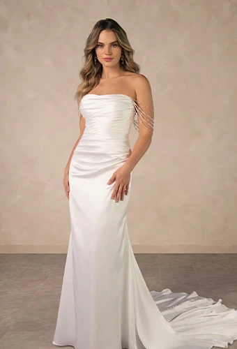 Bride wearing strapless column wedding dress with draped pearls
