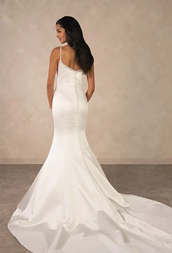 Bride wearing satin fit-and-flare wedding dress with beaded spaghetti straps