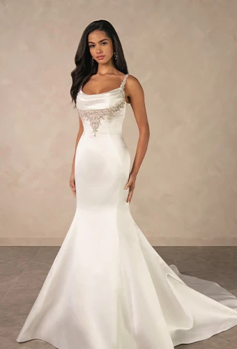 Bride wearing satin fit-and-flare wedding dress with beaded spaghetti straps and cowl neckline