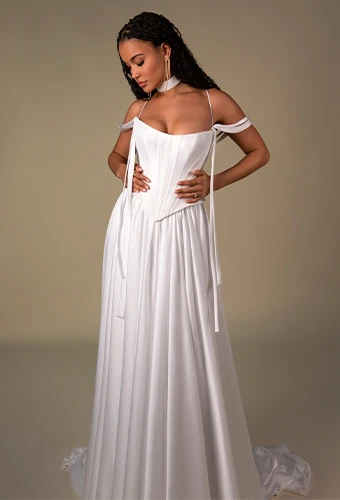 Bride wearing chiffon a-line wedding dress with ribbons and off-the-shoulder straps
