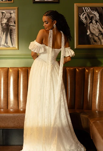 Bride wearing a-line boho wedding dress with off-the-shoulder puff sleeves