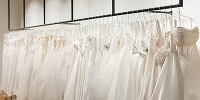 rack of hanging wedding dresses