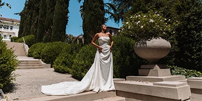 bride wearing a strapless column wedding dress with overskirt