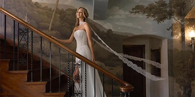 bride walking up stairs with her bridal scarf floating behind her
