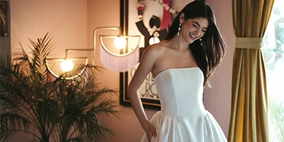 bride wearing simple a-line wedding dress with hands in pockets