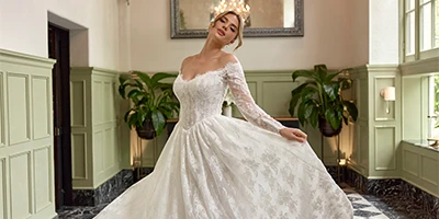 bride twirling in lace long sleeve wedding dress
