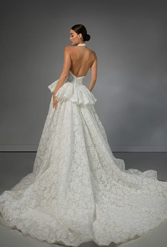 Bride wearing lace halter wedding dress with high neckline and peplum waist