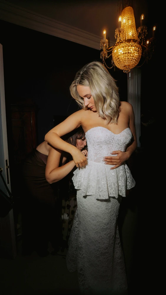 True bride Sarah putting on her wedding gown