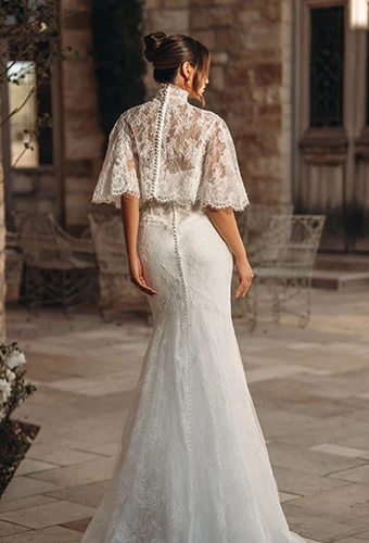 Bride wearing strapless lace fit-and-flare wedding dress with optional lace jacket
