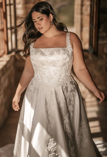 Plus size bride wearing jacquard wedding dress with square neckline and straps