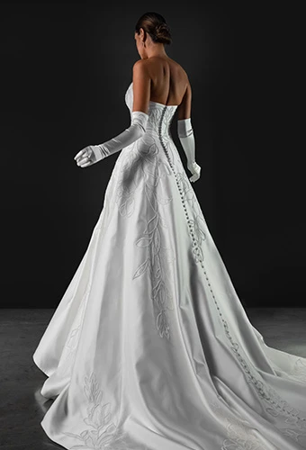 Bride wearing strapless wedding dress with straight across neckline and optional gloves