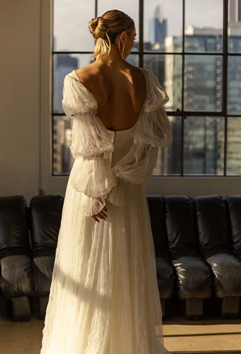 Bride wearing boho wedding gown with statement sleeves