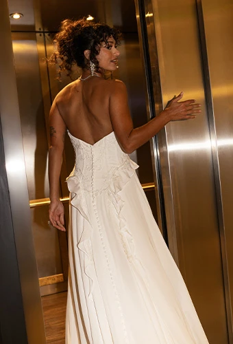 Bride wearing strapless boho wedding dress with sweetheart neckline