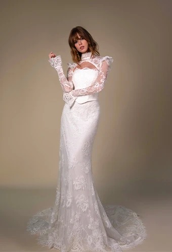 Bride wearing corseted sheath wedding dress with detachable sleeves.