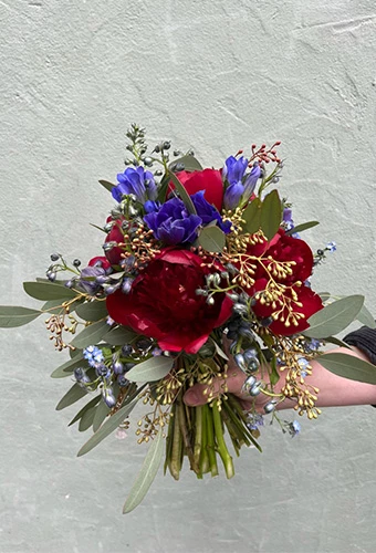Winter bridal bouquet with Christmas roses, proteas, eucharis and delicate wax flowers.