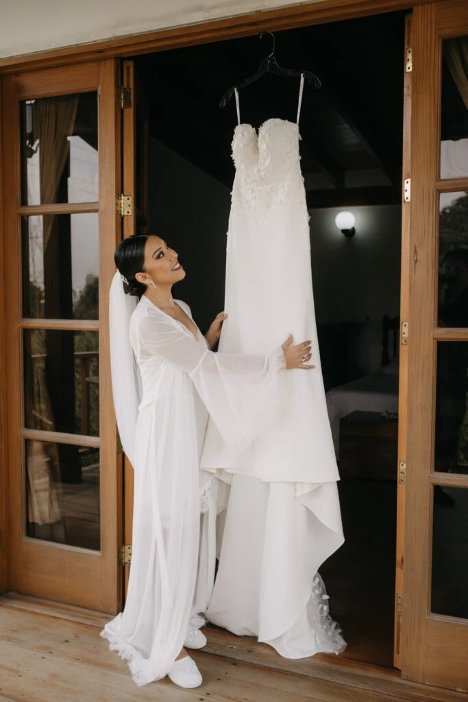 True Bride Mayra looking at her wedding gown