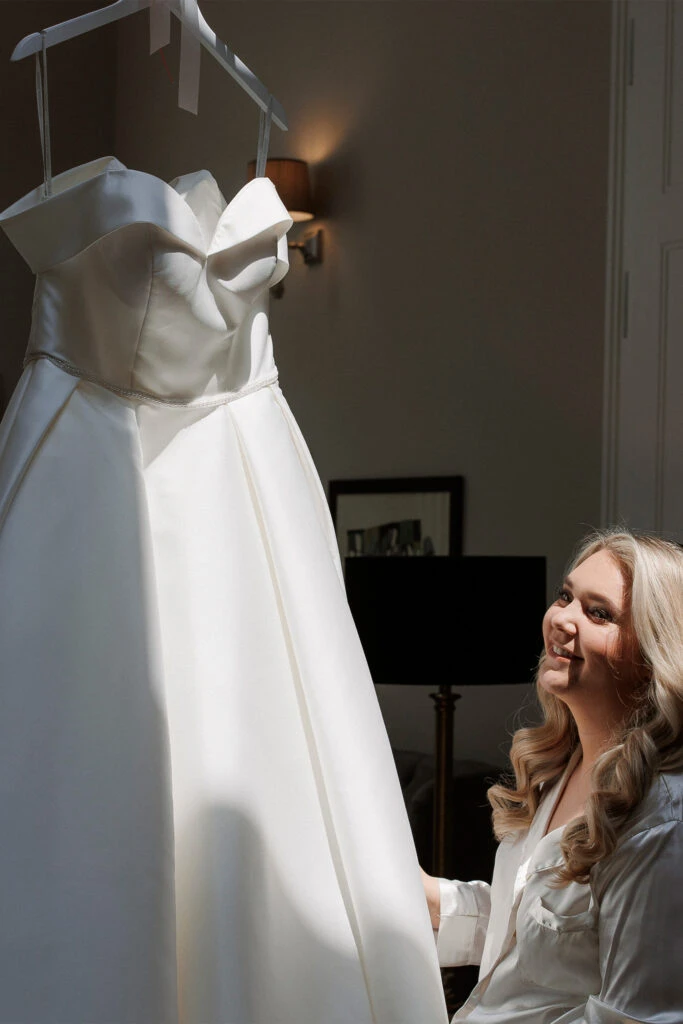 True Bride Janine looking at her wedding dress