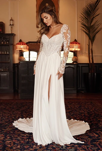 Bride wearing flowy lace a-line wedding dress with cutouts and open back