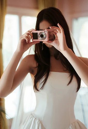 Bride taking photos with a camera