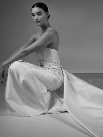bride posing in a satin sheath wedding dress with train by Martina Liana Luxe