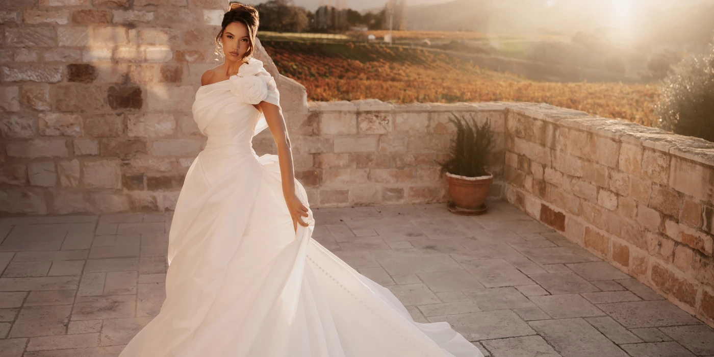 bride wearing modern ballgown wedding dress standing in tuscan courtyard