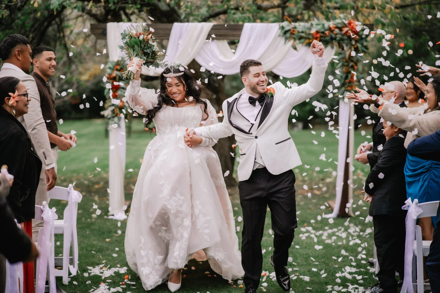 True bride celebrating down the aisle with her husband