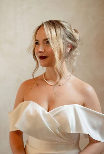 Bride wearing Martina Liana Luxe style LE1202, a modern column sheath wedding dress, featuring a pearl necklace
