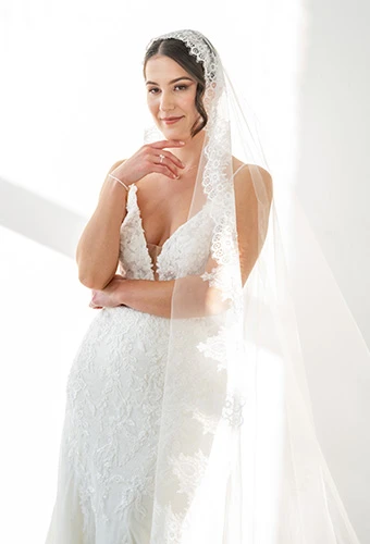 Bride wearing ML1305, a 3D lace wedding dress with a v-neck and beading detail, paired with a stunning veil