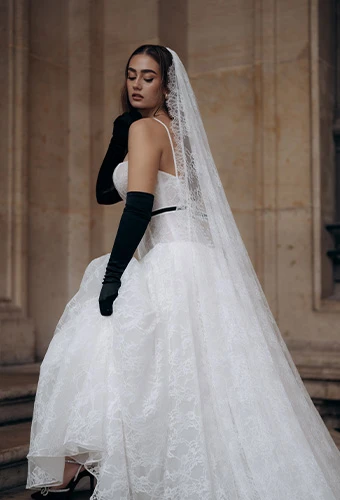 Bride wearing ML1907, an A-line wedding dress with a sweetheart neckline, featuring a stunning cathedral veil