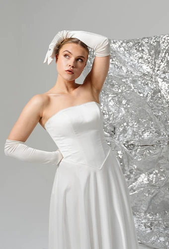 Bride wearing SY8091, a strapless wedding dress with chic tie-up detail paired with modern gloves