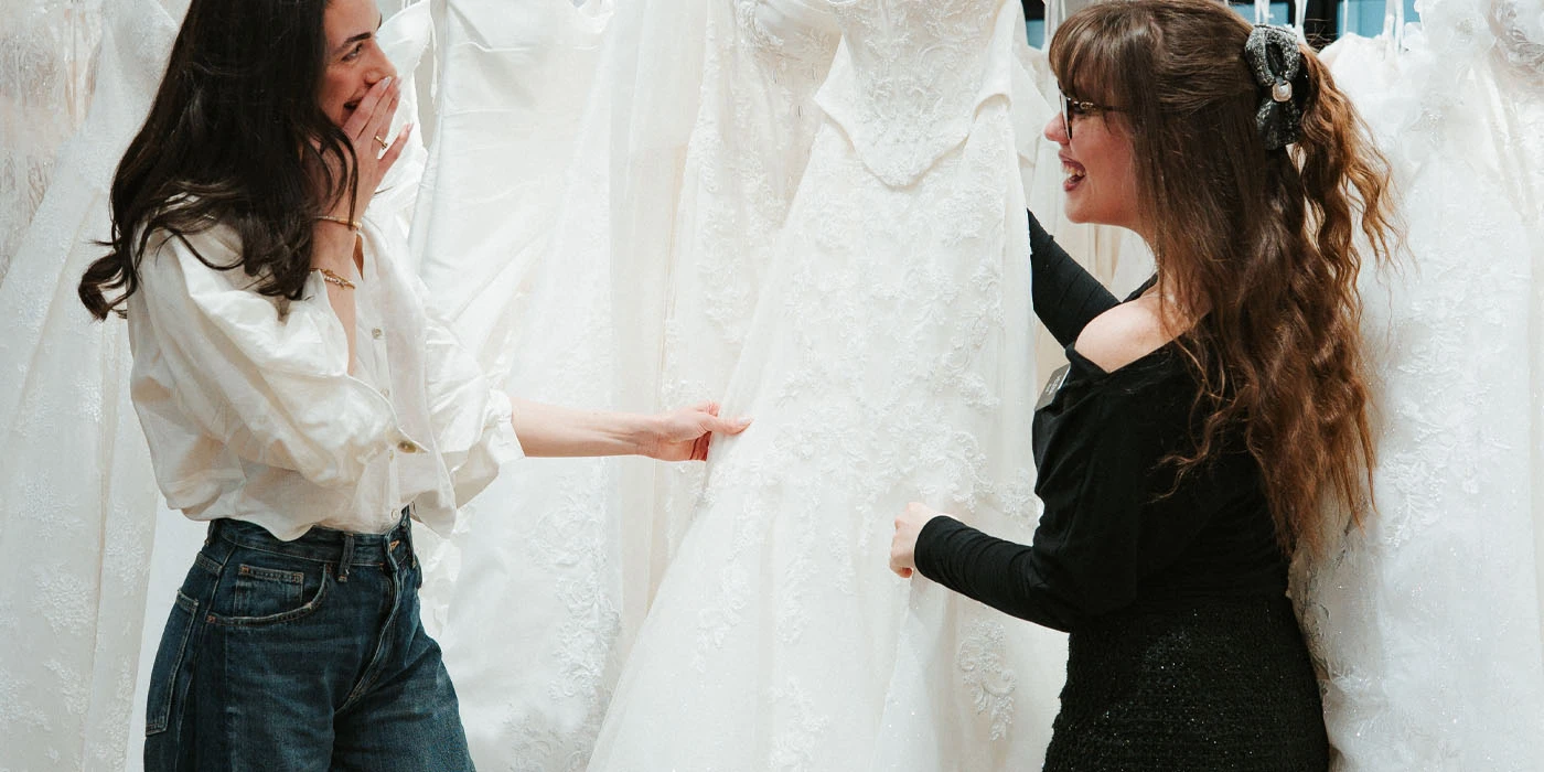 bride shopping racks of wedding dresses at True Society