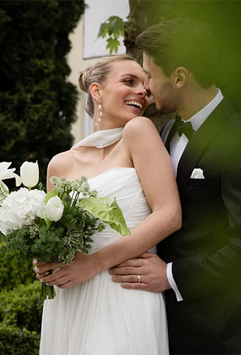 Bride wearing All Who Wander avalon, a strapless a-line wedding gown, featuring statement earrings